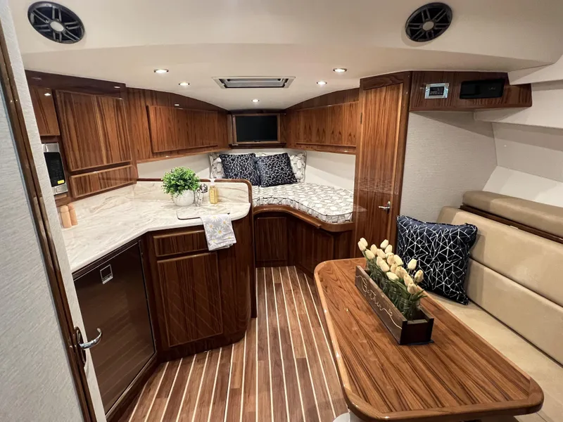 Slide: The Image of Luxurious interior of 2025 Henriques 35 Express Hardtop with wood finish and modern amenities. - 14