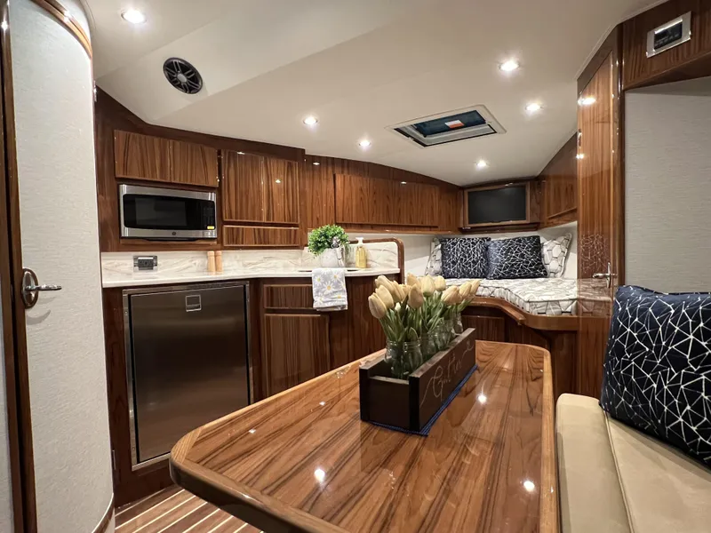 Slide: The Image of Luxurious interior of 2025 Henriques 35 Express Hardtop yacht with modern kitchen and seating area. - 17