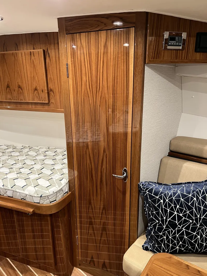 Slide: The Image of 2025 Henriques 35 Express Hardtop interior with wood finish and modern furnishings. - 20