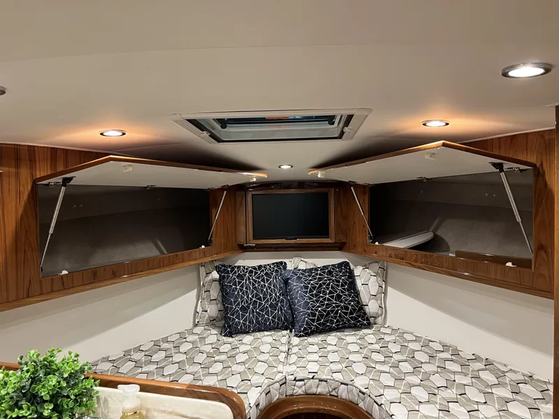 Slide: The Image of 2025 Henriques 35 Express Hardtop cabin interior with modern design and geometric-patterned bedding. - 22
