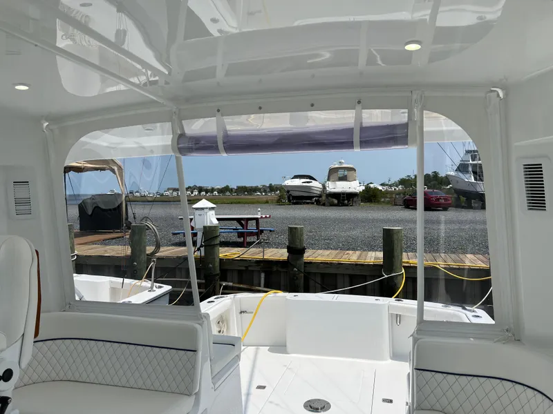 Slide: The Image of 2025 Henriques 35 Express Hardtop interior view at marina dock. - 25