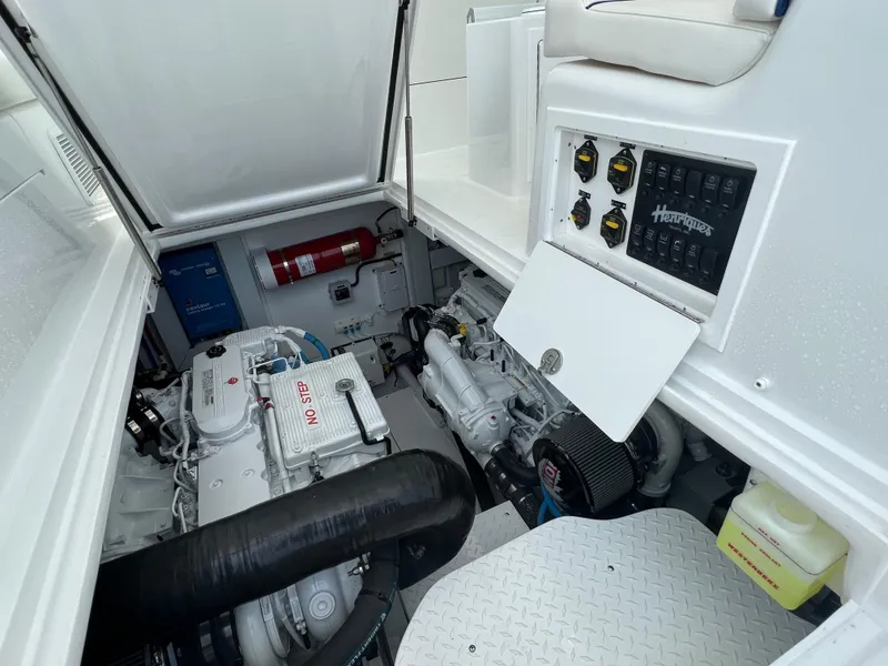 Slide: The Image of Engine compartment of 2025 Henriques 35 Express Hardtop with visible control panel and fire extinguisher. - 27