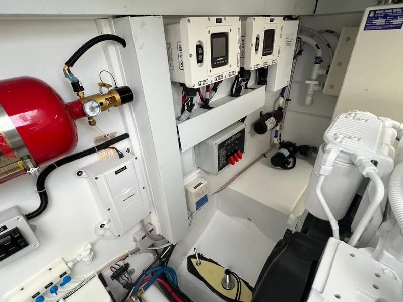 Slide: The Image of Engine room of 2025 Henriques 35 Express Hardtop, featuring control panels and safety equipment. - 28