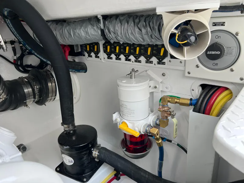 Slide: The Image of Engine compartment of 2025 Henriques 35 Express Hardtop, showcasing mechanical components and wiring. - 31