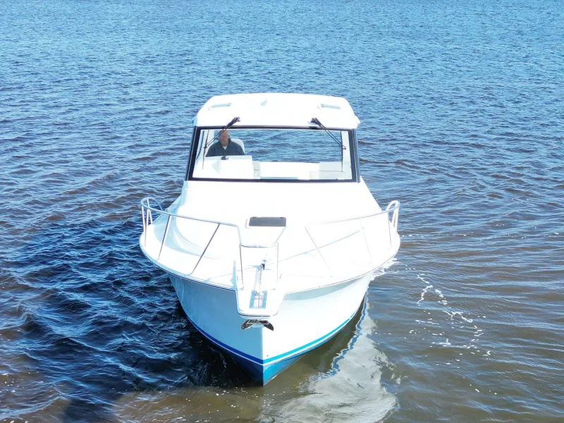 Slide: The Image of 2025 Henriques 35 Express Hardtop boat cruising on open water. - 6