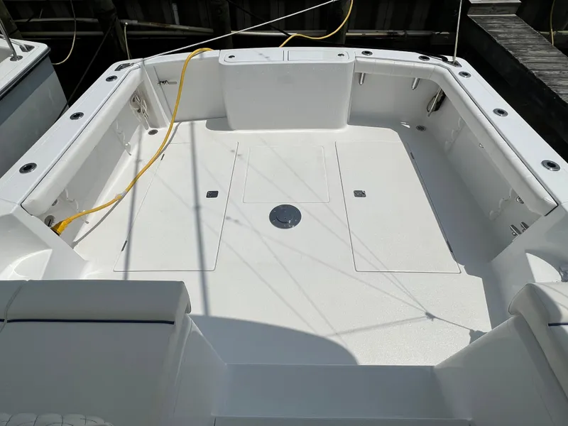 Slide: The Image of 2025 Henriques 35 Express Hardtop boat deck, spacious and clean with storage compartments. - 9