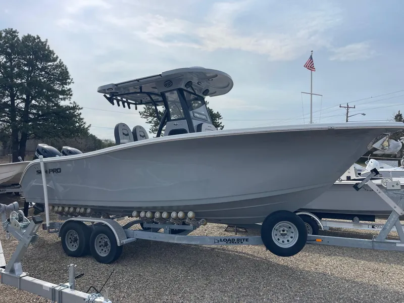 The Image of 2025 Sea Pro 262 Offshore boat on trailer, parked outdoors under cloudy sky. - 0