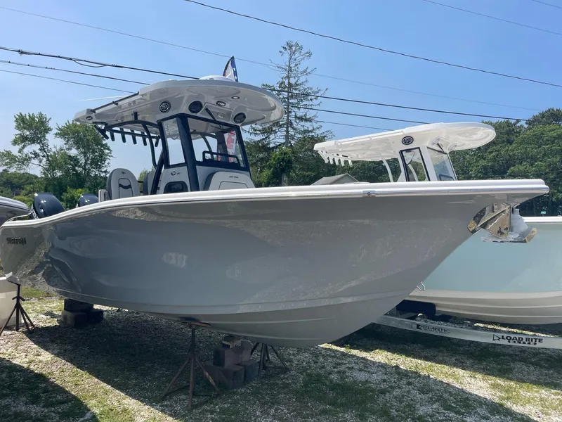 Slide: The Image of 2025 Sea Pro 262 Offshore boat displayed outdoors on a sunny day. - 1