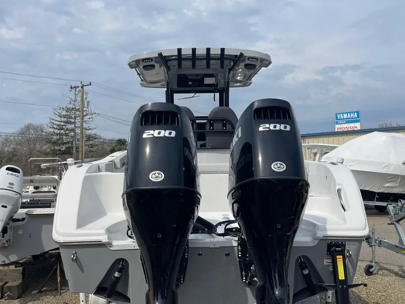 Slide: The Image of 2025 Sea Pro 262 Offshore boat with dual 200 horsepower engines, docked outdoors. - 10