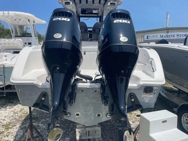 Slide: The Image of 2025 Sea Pro 262 Offshore boat with dual 200 horsepower engines, displayed at a marine store. - 11