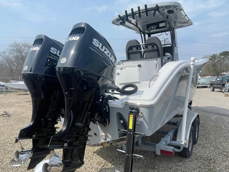 Slide: The Image of 2025 Sea Pro 262 Offshore boat with dual Suzuki engines on a trailer. - 12