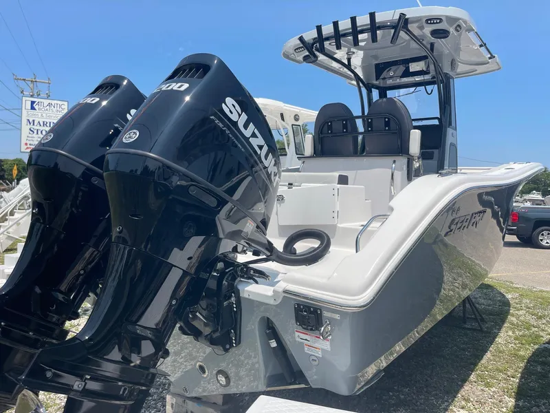 Slide: The Image of 2025 Sea Pro 262 Offshore boat with dual Suzuki engines, displayed outdoors. - 13