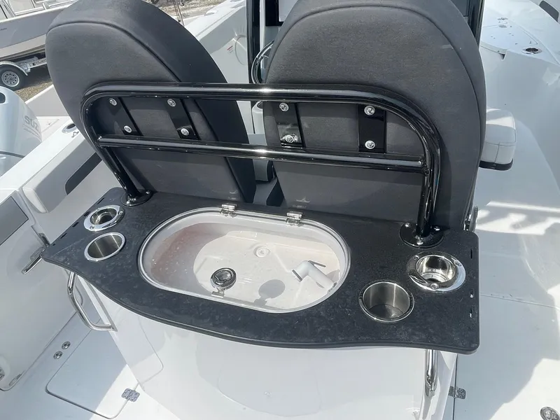 Slide: The Image of 2025 Sea Pro 262 Offshore boat with a sleek black console and cup holders. - 25