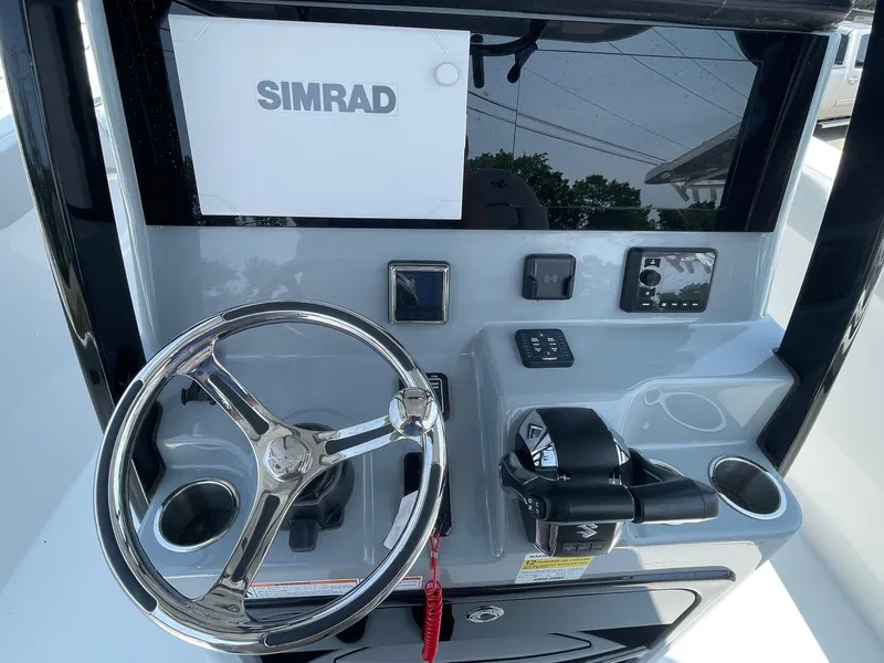 Slide: The Image of 2025 Sea Pro 262 Offshore helm with Simrad display and steering wheel. - 27