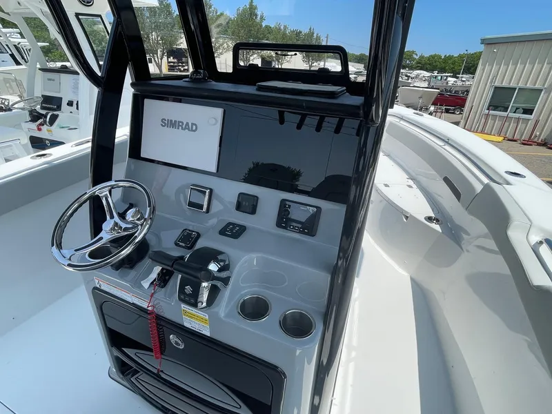 Slide: The Image of 2025 Sea Pro 262 Offshore boat console with steering wheel and Simrad display. - 29