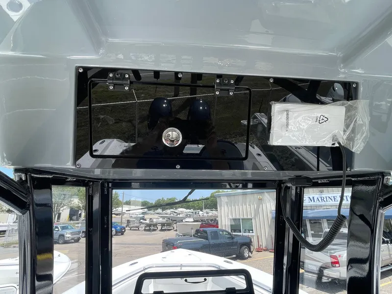 Slide: The Image of 2025 Sea Pro 262 Offshore boat dashboard with storage compartment and marina background. - 30