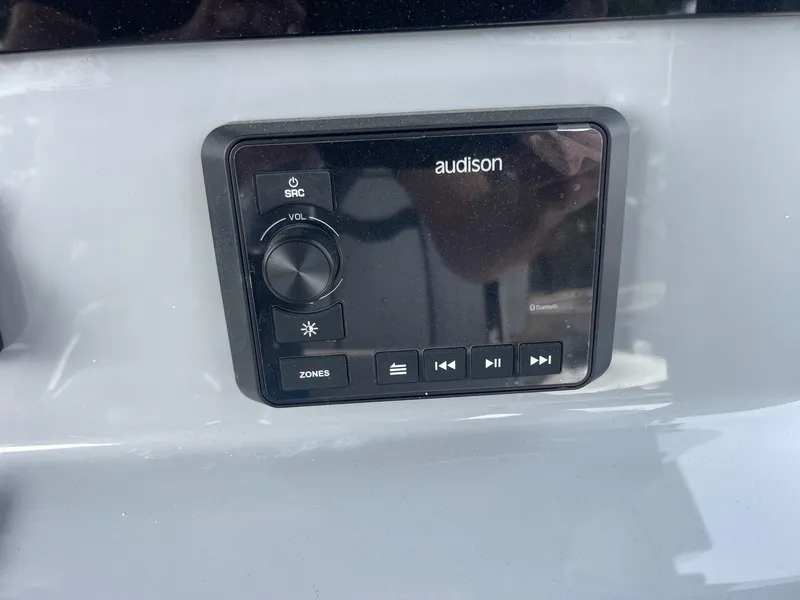 Slide: The Image of Audison audio control panel on 2025 Sea Pro 262 Offshore boat dashboard. - 32