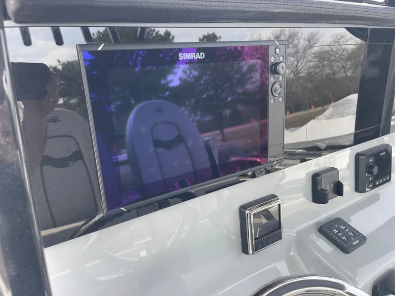 Slide: The Image of 2025 Sea Pro 262 Offshore dashboard with Simrad display and control panel. - 33