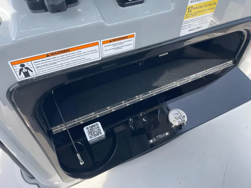 Slide: The Image of 2025 Sea Pro 262 Offshore storage compartment with warning labels and QR code. - 37
