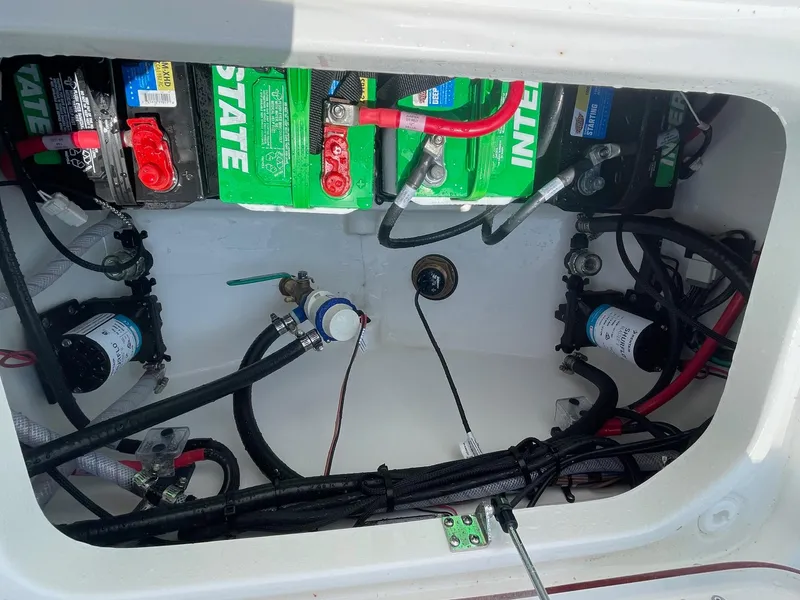 Slide: The Image of 2025 Sea Pro 262 Offshore boat battery compartment with wiring and components. - 46