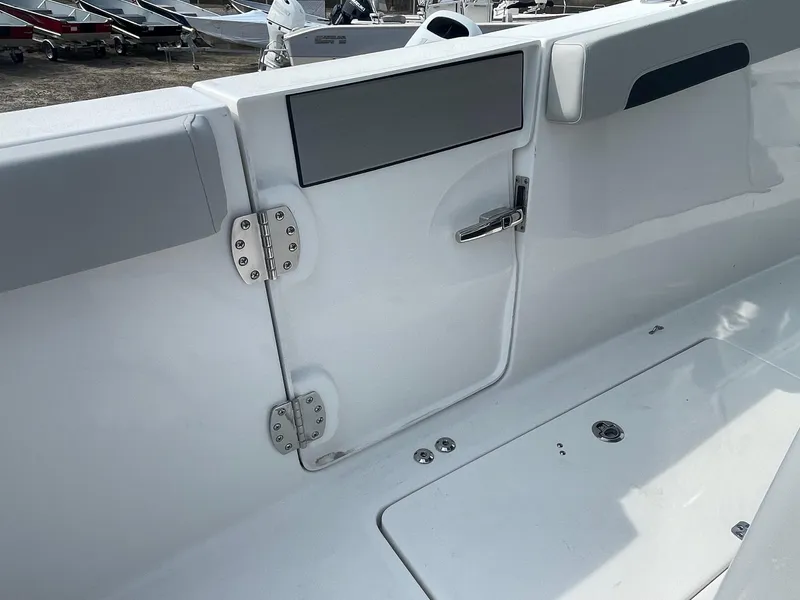 Slide: The Image of 2025 Sea Pro 262 Offshore boat interior, featuring sleek white design and stainless steel hardware. - 51