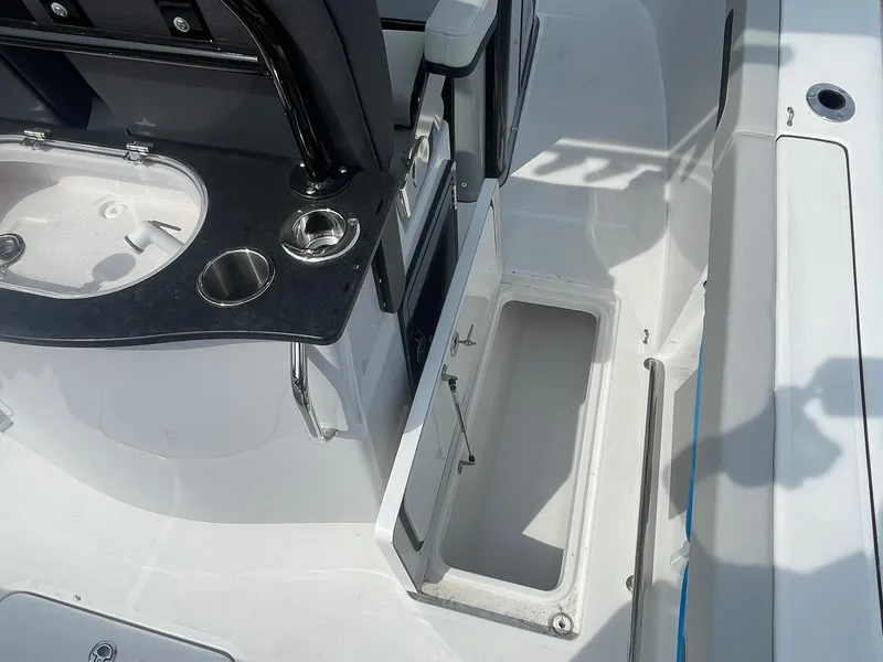 Slide: The Image of 2025 Sea Pro 262 Offshore boat interior with storage compartments and cup holders. - 55