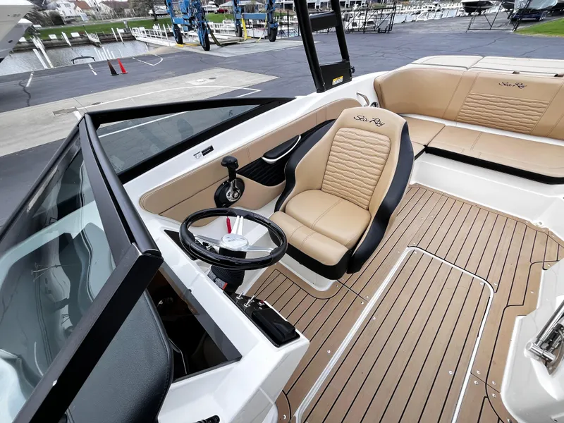 Slide: The Image of 2022 Sea Ray SPX 210 boat interior with tan seating and sleek design. - 4