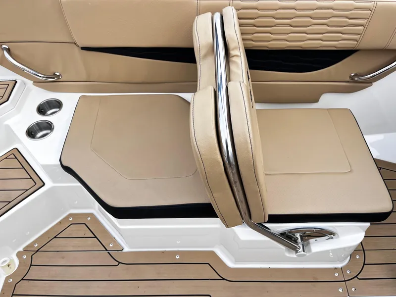 Slide: The Image of 2022 Sea Ray SPX 210 boat interior with tan seating and stainless steel accents. - 5