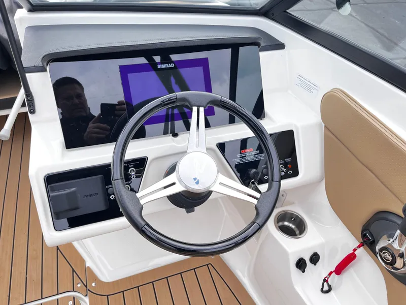 Slide: The Image of 2022 Sea Ray SPX 210 boat dashboard with steering wheel and navigation display. - 6