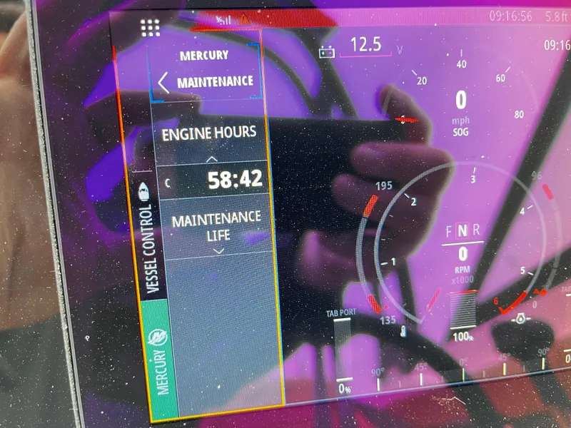 Slide: The Image of Display screen of a 2022 Sea Ray SPX 210 showing engine hours and maintenance details. - 7