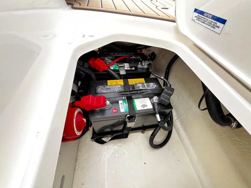 Slide: The Image of Battery compartment of 2022 Sea Ray SPX 210 boat, featuring wiring and secure installation. - 8