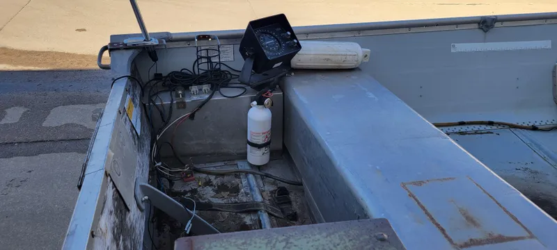 Slide: The Image of 1988 Lowe 14' V boat interior with equipment and fire extinguisher. - 10