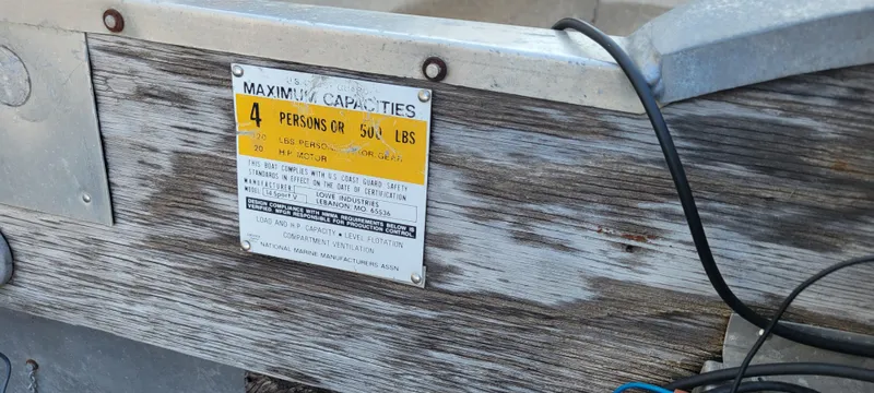 Slide: The Image of 1988 Lowe 14' V boat capacity plate, maximum 4 persons or 560 lbs. - 11