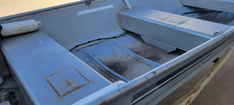 Slide: The Image of 1988 Lowe 14' V boat interior, showing metal seats and flooring. - 13