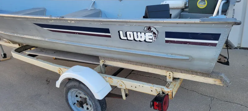 Slide: The Image of 1988 Lowe 14' V aluminum boat on trailer, side view. - 5