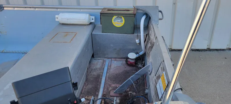 Slide: The Image of 1988 Lowe 14' V boat interior with storage and equipment. - 9