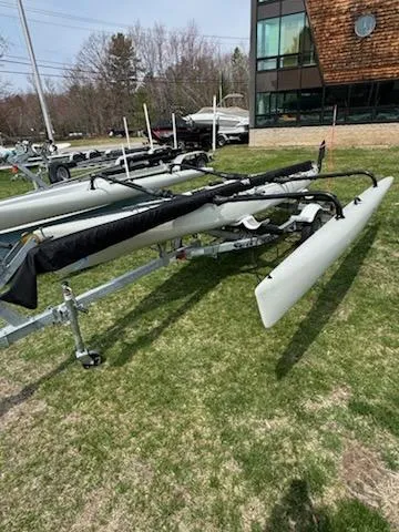 Slide: The Image of 2012 Hobie Mirage Tandem Island kayak on trailer, displayed outdoors near a building. - 3