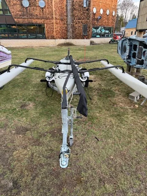 Slide: The Image of 2012 Hobie Mirage Tandem Island kayak with outriggers on grass near a building. - 7