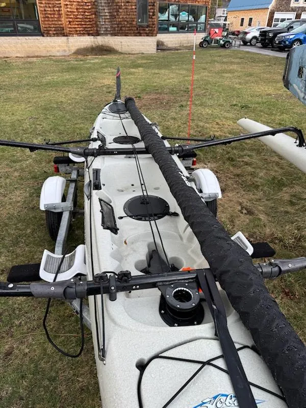 Slide: The Image of 2012 Hobie Mirage Tandem Island kayak on trailer, parked on grass. - 8