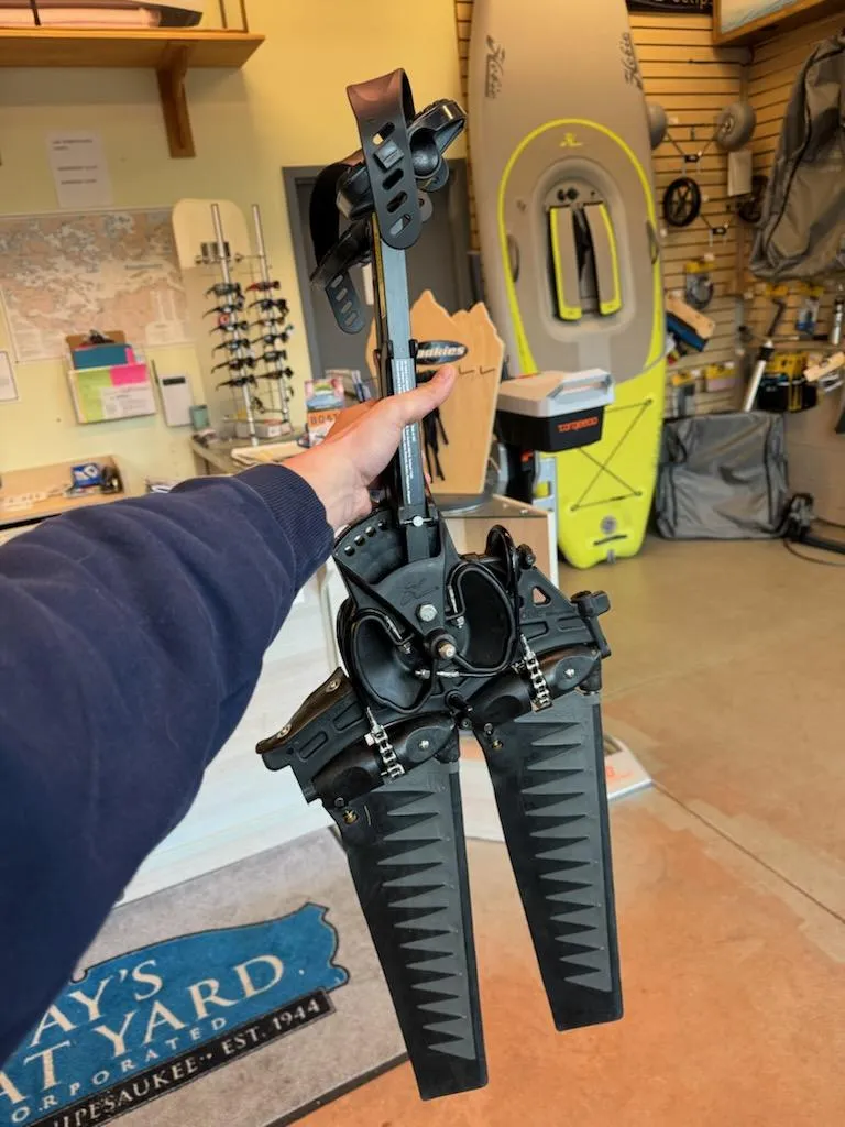 Slide: The Image of Hand holding Hobie Mirage Tandem Island kayak pedal drive system in a store setting. - 9