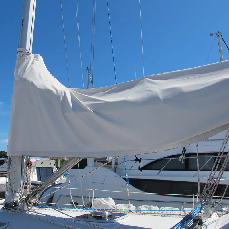 Slide: The Image of Sailboat with covered mainsail, Catalina 42 MkII, 1997 model, docked under clear blue sky. - 11