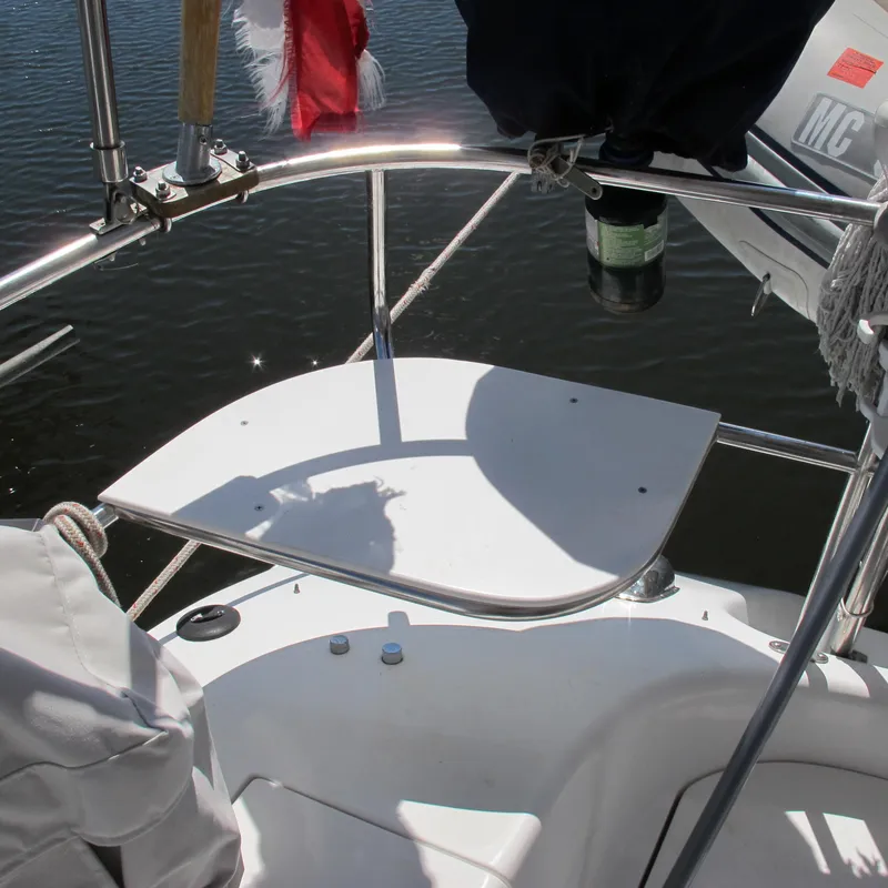 Slide: The Image of Sailboat cockpit of 1997 Catalina 42 MkII with stainless steel railings and water reflections. - 15