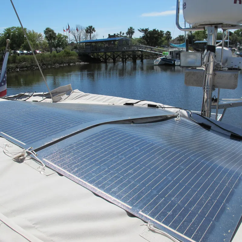 Slide: The Image of Solar panels on a 1997 Catalina 42 MkII sailboat docked by a scenic river. - 18