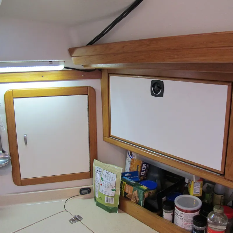 Slide: The Image of Interior of 1997 Catalina 42 MkII sailboat with wooden cabinets and storage area. - 22