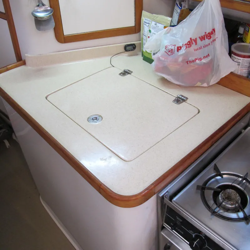 Slide: The Image of Catalina 42 MkII 1997 yacht kitchen with stove and countertop storage. - 25