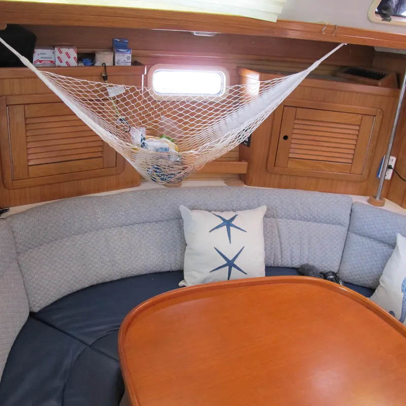 Slide: The Image of Cozy interior of 1997 Catalina 42 MkII sailboat with net storage and starfish pillows. - 27