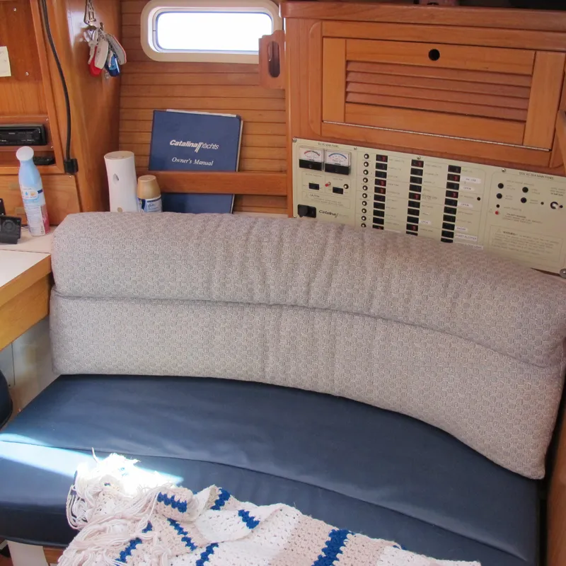 Slide: The Image of Cozy interior of a 1997 Catalina 42 MkII sailboat with seating and control panel. - 28