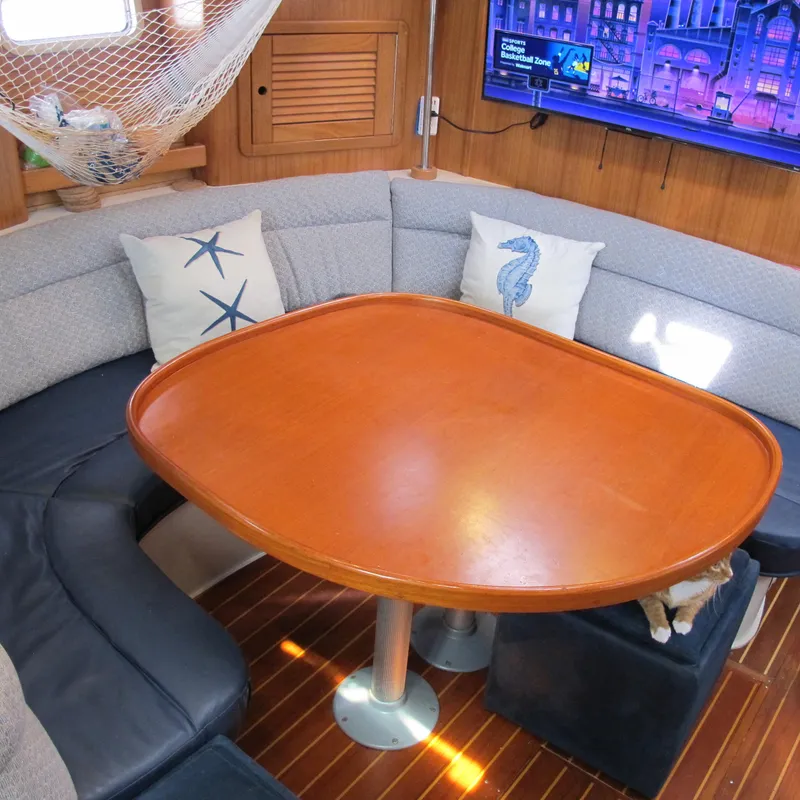 Slide: The Image of Cozy interior of 1997 Catalina 42 MkII sailboat with wooden table and nautical decor. - 30