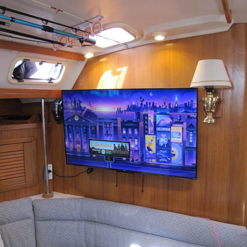 Slide: The Image of Interior of a 1997 Catalina 42 MkII yacht with TV and fishing rods. - 31
