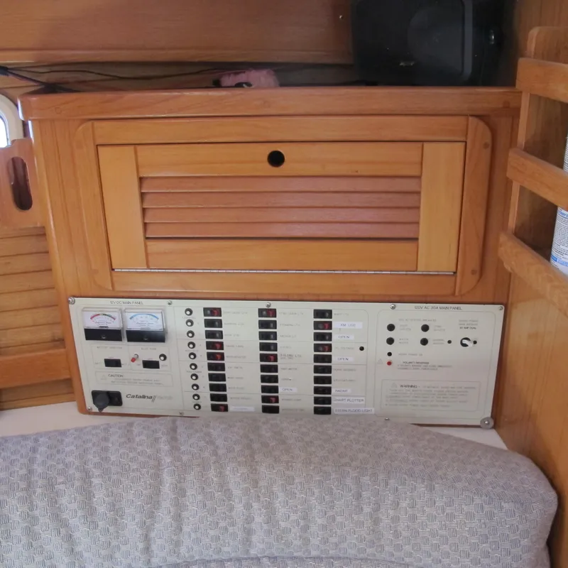 Slide: The Image of Electrical panel and wooden cabinet inside a 1997 Catalina 42 MkII sailboat. - 32